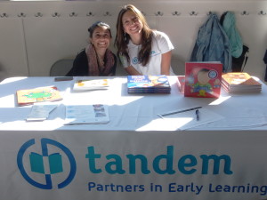 Tandem staff members sharing books and free resources at Refugee Transitions event.