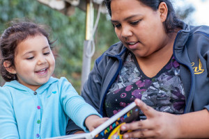 girl-and-mom-pointing-at-book-great-photo-1