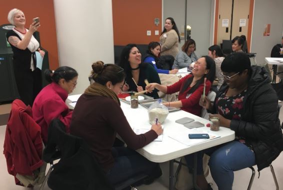 Our keynote speaker (to the far left), Michelle Grant-Groves, records this group of educators as they use their materials and voices to make music together.